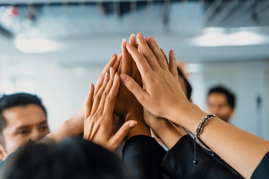 Many happy business people raise hands together with joy and success. Company employee celebrate after finishing successful work project. Corporate partnership and achievement concept. uds