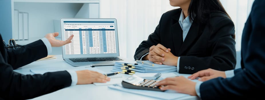 Corporate accountant team use accounting software on laptop to calculate and maximize tax refund and improve financial performance base on financial data. Modern business accounting . Shrewd