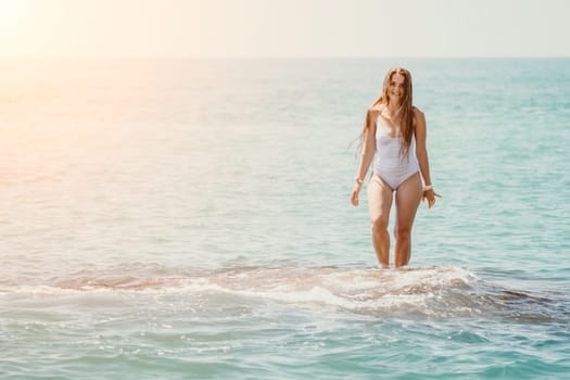 Woman sea yoga. Back view of free calm happy satisfied woman with long hair standing on top rock with yoga position against of sky by the sea. Healthy lifestyle outdoors in nature, fitness concept.