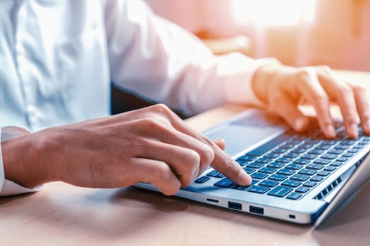 Businessman hand typing on computer keyboard of a laptop computer in office. Business and finance concept. uds