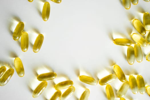 Close up capsules of Omega 3 on white background. Health care concept. Medical pill or vitamin's capsule pattern. Medicine, healthcare or pharmacy concept