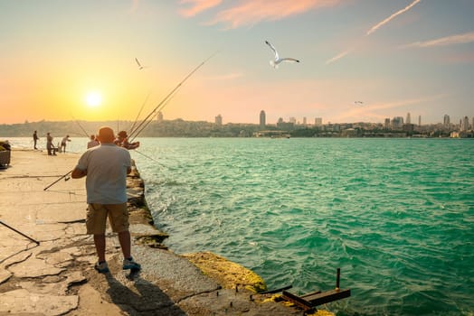 Fishermen fishing on the Bosphorus at sunset