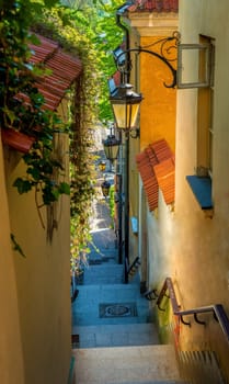 Narrow street with stairs and lamps in the Old town of Warsaw, Poland