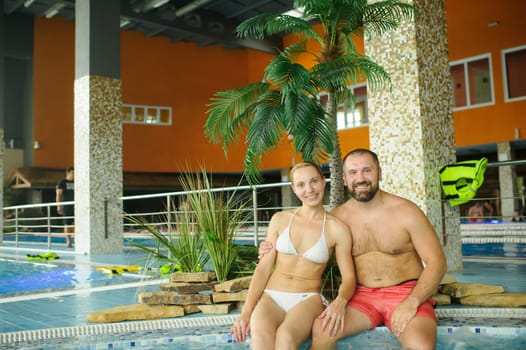 Portrait of a couple enjoying a vacation in the pool.