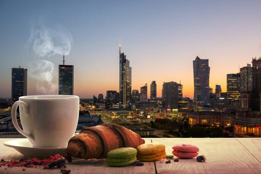 Tea and macaroons against the backdrop of the skyscrapers of Warsaw