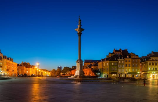 The Royal Castle square and King Sigismunds Column in Warsaw city at night, Poland