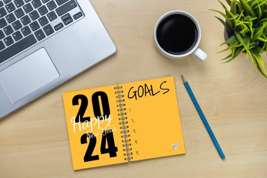 2024 Happy New Year Resolution Goal List and Plans Setting - Business office desk with notebook written about plan listing of new year goals and resolutions setting. Change and bliss concept.