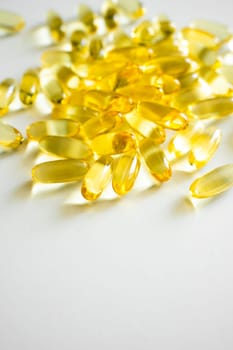 Close up cod liver oil omega 3 gel capsules. Fish oil capsules with omega 3 on white background