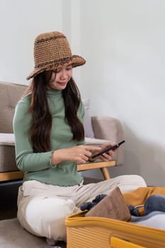 Happy Woman using smartphone booking vacation at travel agency or making hotel reservation online.
