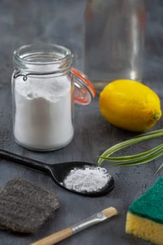 Baking soda, vinegar and cut lemons on white wooden table, flat lay.