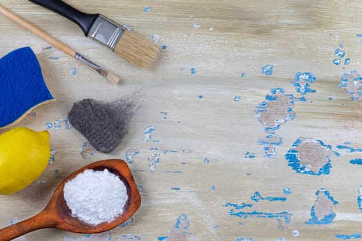 Baking soda, vinegar and cut lemons on white wooden table, flat lay.