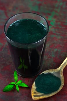 Organic green spirulina powder background. Super foods, food supplement source of vitamin protein and beta carotene.