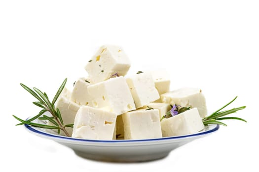 Feta cheese cubes isolated on white background with clipping path. Heap of Feta cheese, basil leaves and tomatoes.