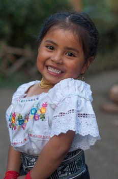 vertical photo of indigenous girl from Latin America very smiling, happy and excited looking at camera, beautiful look of a girl. High quality photo