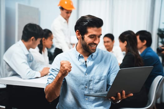 Engineer team leader portrait with diverse group of civil engineer and client working together on architectural project, reviewing construction plan and building blueprint at meeting table. Prudent