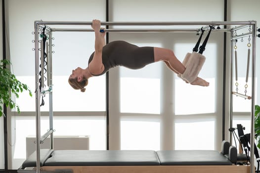 Pregnant woman doing pilates on a reformer