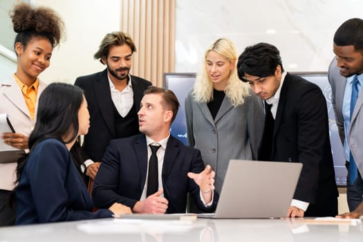 Multicultural businesspeople brainstorming business idea together. Diverse professional business team working together, sharing, planing idea, strategy. Meeting room, laptop, presentation. Ornamented.