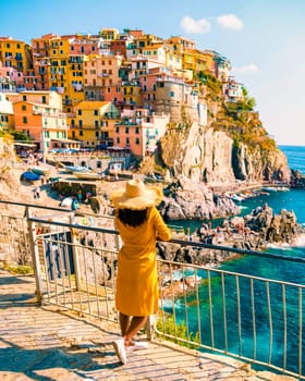 Asian women visiting Manarola in Cinque Terre Italy, Manarola Village, Cinque Terre Coast Italy. Manarola is a beautiful colorful town of La Spezia, Liguria, and one of the five Cinque Terre