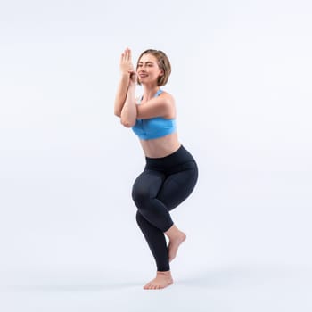 Full body length gaiety shot athletic and sporty woman doing healthy and meditative yoga exercise workout posture on isolated background. Healthy active and body care lifestyle