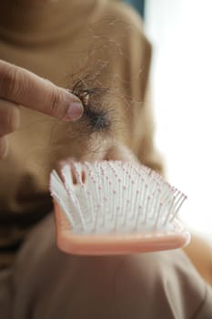 women hold her lost hair close up ,