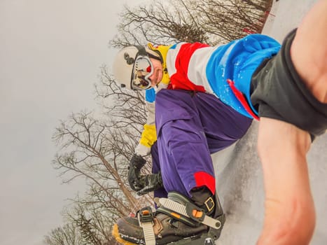 A daring man conquers snowy slopes with style, showcasing skill and thrill as he maneuvers on a snowboard, capturing the essence of winter adventure.