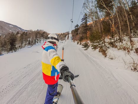 A daring man conquers snowy slopes with style, showcasing skill and thrill as he maneuvers on a snowboard, capturing the essence of winter adventure.