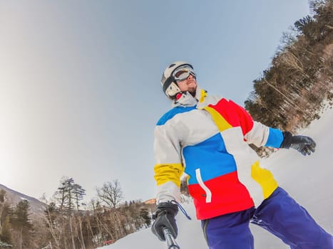 A daring man conquers snowy slopes with style, showcasing skill and thrill as he maneuvers on a snowboard, capturing the essence of winter adventure.