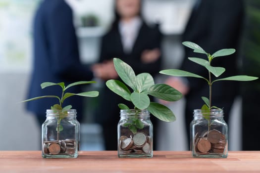 Organic money growth investment concept shown by money savings in glass jar. Financial investments rooted and cultivating wealth in harmony with nature. Quaint