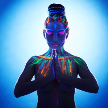 Studio shot of fantasy woman with hands in Namaste prayer pose