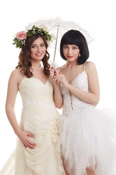 Beautiful brides posing at camera. Concept of double wedding