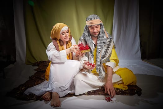 A couple in love or a married couple in stylized Eastern clothing from Israel, Palestine, Iran, Pakistan together. Tender photo session in the style of the Middle East and the Bible