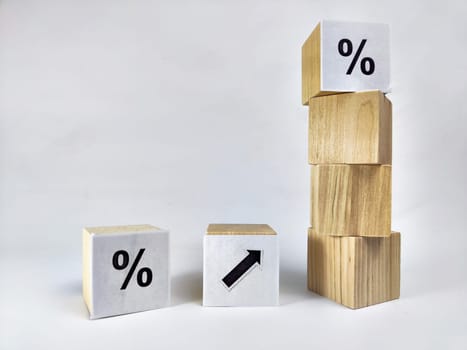 Wooden cubes with arrows and percentages on black background. Stages of action and goal achievement. Planning. Business actions. Receiving income and profit