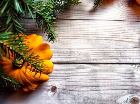 Festive decoration with bouquet and branches of spruce, oranges and wooden background. Decor for Christmas and New Year. Abstract texture, frame, place for text and copy space