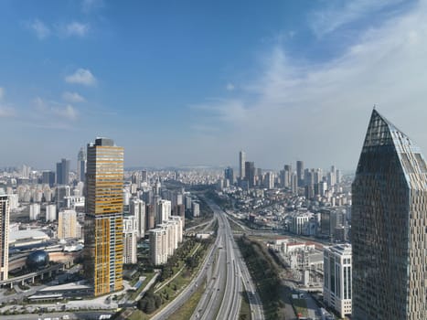 Cinematic aerial view of city skyline, modern business financial skyscrapers building and shopping mall of Istanbul, Turkey at sunny winter day with blue sky drone establishment shot