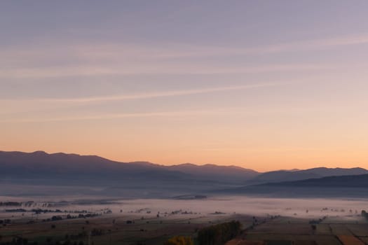 aerial view of foggy morning autumn mountains with clouds bansko bulgaria.