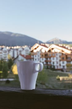 a cup of tea against the backdrop of the hotel and beautiful mountains in Bansko, Bulgaria.