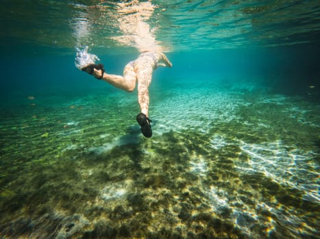 Diver enjoying a serene shallow dive with clear visibility.