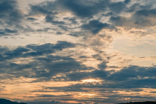 Abstract background sky Dawn Sunset Contrast dark shadow bright cloud sun orange silhouette above the mountains near the sea.