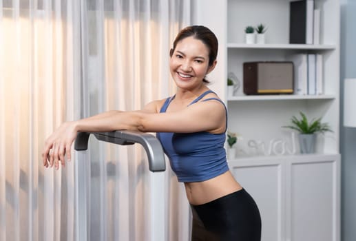 Asian woman in sportswear portrait, smiling and posing cheerful gesture. Home workout training or exercise fitness lifestyle. Attractive girl engage in her pursuit of healthy lifestyle. Vigorous