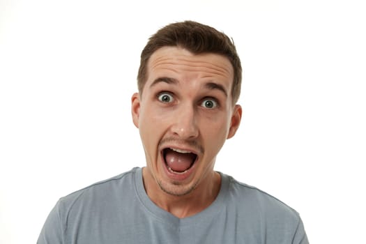 surprised guy looking at camera on white studio background