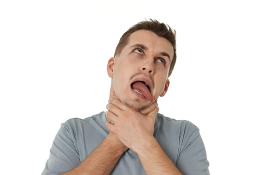 guy grimaces and grabs his throat with his hands on white background.