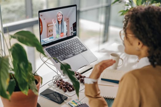 Stylish business woman have video conference with client while sitting in office