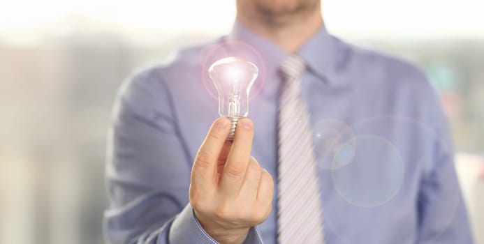 Innovation Technology New Creative Business Idea. Businessman in Shirt Hold Traditional Light Bulb. Married Executive Manager with Lamp in Hand. Saving Energy and Accounting Finance in Office Concept