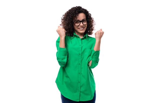 portrait of an authentic young creative agent woman with curly hair dressed in a green shirt.
