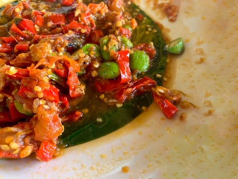 Sambal Pete (Petai) or bitter bean with chilli sauce, parkia speciosa, a popular Indonesian dish. Delicious food at a restaurant in Bali
