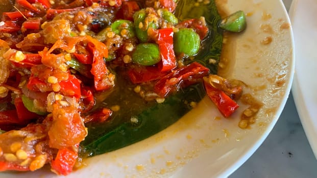 Sambal Pete (Petai) or bitter bean with chilli sauce, parkia speciosa, a popular Indonesian dish. Delicious food at a restaurant in Bali