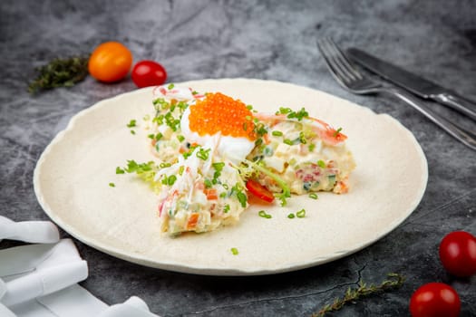 salad with mozzarella, caviar and green onions on a white plate