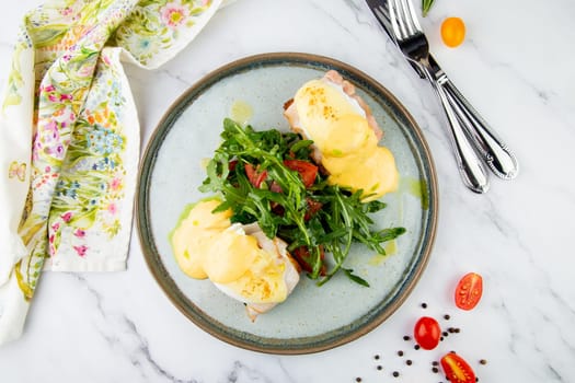 breakfast of arugula and tomato, toast with cheese and poached egg