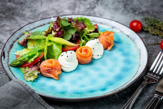 salad of leaves of different types of lettuce and fish rolls