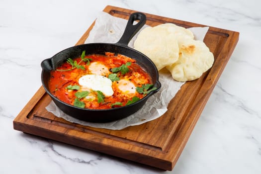 beetroot borscht with sour cream and parsley in a frying pan